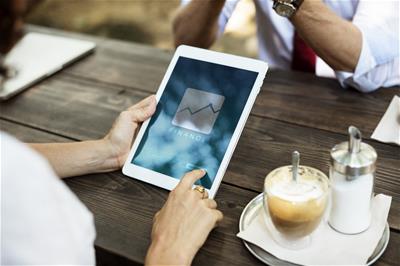 business-2345812_1920 Woman's hands holding a tablet with a website open that says "finance."